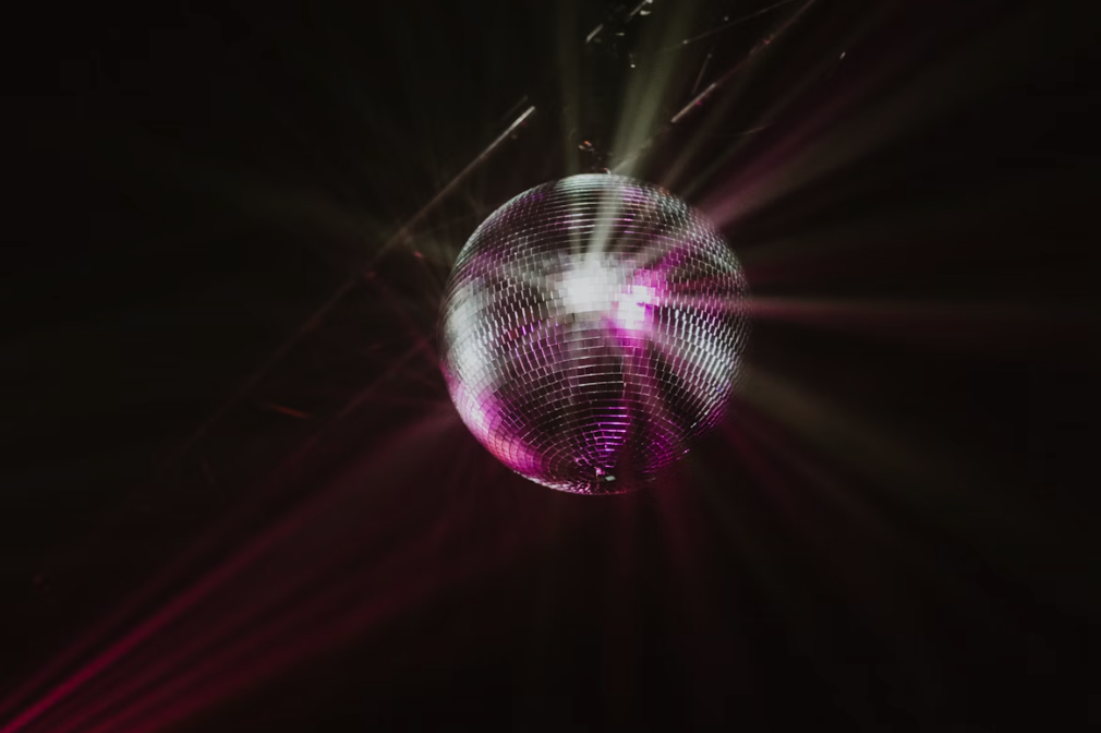 purple and silver disco ball in the dark