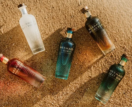 mermaid gin bottles on sand